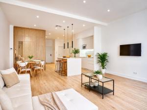 a living room with a white couch and a table at Paseo Suites Hotel in Madrid