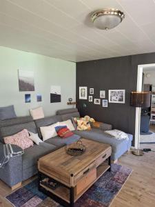 a living room with a couch and a coffee table at Bieber`s Gästezimmer in Lilla Norge