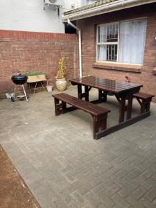 a picnic table and a grill on a patio at Tortilla no 3 in Bloemfontein