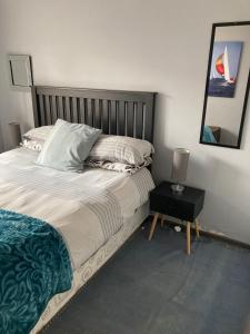 a bedroom with a bed and a table with a lamp at Tortilla no 3 in Bloemfontein