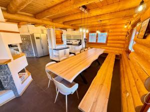 a dining room with a wooden table and chairs at Wellness Chalet Tatry in Vysoké Tatry