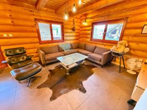 a living room with a couch and a table at Wellness Chalet Tatry in Vysoké Tatry +38 photos