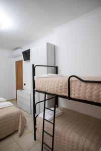 a bedroom with two bunk beds in a room at Introdacqua Holidays in Sulmona