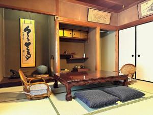a room with a wooden table and a chair at 平城空間 - Heijo Space in Nara