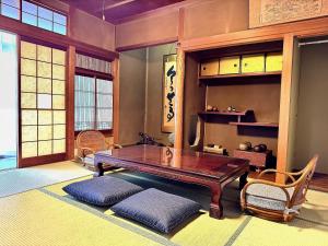 a living room with a wooden table and chairs at 平城空間 - Heijo Space in Nara