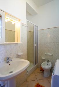 a bathroom with a sink and a toilet at Appartamenti Elios in Birgi Vecchi +15 photos