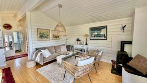 a living room with a couch and chairs at Atlantic Shoreline Cabin in Vestvågøya