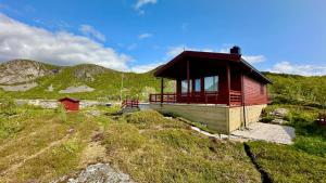 a small cabin on top of a hill at Atlantic Shoreline Cabin in Vestvågøya
