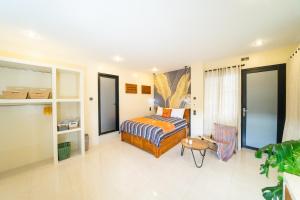a hotel room with a bed and a chair at Casa Seraya Dalung in Dalung