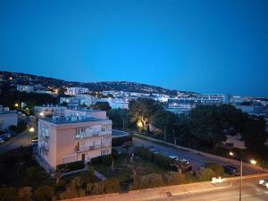 a view of a city at night at studio cabine vue sur mer in Sète