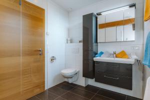a bathroom with a sink and a toilet at Appartement Lackner mit Seeblick in Weissensee +91 photos