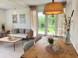 a living room with a wooden table with a couch at Keizerskroon 239 in Julianadorp