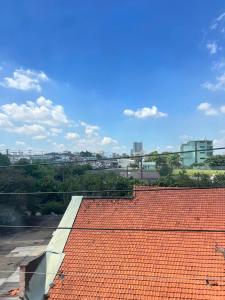 a red tile roof with a city in the background at Khách Sạn Vũ Nam Hưng in Ấp Hưng Lộc