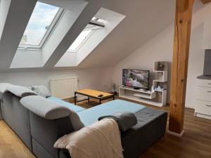 a living room with a couch and a tv at StayCentralcz- Loft in Opava