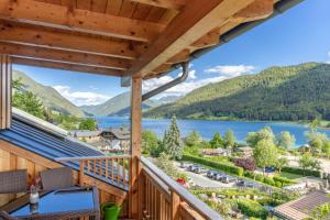 a balcony with a view of a lake and mountains at Appartement Lackner mit Seeblick in Weissensee