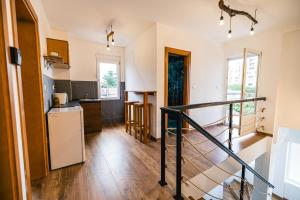 a kitchen with a staircase leading up to a living room at Late Story in Podgorica
