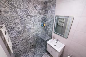 a bathroom with a sink and a mirror at Late Story in Podgorica +16 photos