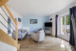 a living room with a couch and a chair at Gite cap 3KM plages in Telgruc-sur-Mer