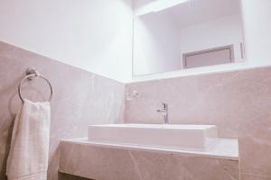 a bathroom with a white sink and a mirror at Apartment in Tilisi in Gatimu +34 photos