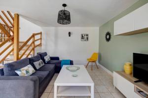 a living room with a blue couch and a table at Gite Aber 3km plages in Telgruc-sur-Mer
