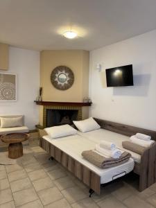 a bedroom with two beds and a fireplace at Filoxenia Studios in Skliri