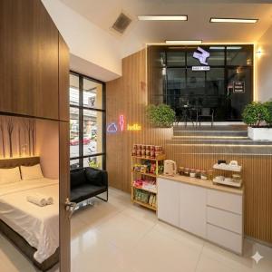 a room with a bed and a counter with a store at Rabbit Room in Bangkok