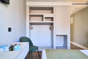 a room with a bed and a desk and a chair at Hostal Sol y Miel in Benalmádena