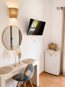a room with a desk and a mirror on the wall at Pension Anastasia in Ammouliani +44 photos