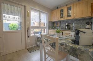 a kitchen with a counter and a table with a printer at Le 10 de coeur in Lusigny-sur-Barse +11 photos