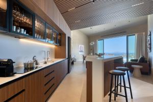 a kitchen with a bar with a view at Elysium Caved Villas - Carved From Calm by etouri in Heraklio