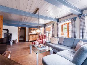 a living room with a couch and a table at Reetdachhaus Silvi in Schwabstedt