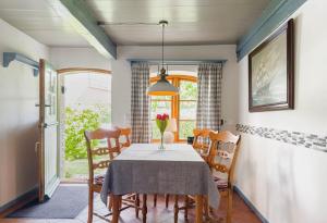 a dining room with a table and chairs at Reetdachhaus Silvi in Schwabstedt +16 photos