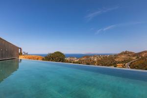 a swimming pool with a view of the ocean at Elysium Caved Villas - Carved From Calm by etouri in Heraklio +173 photos