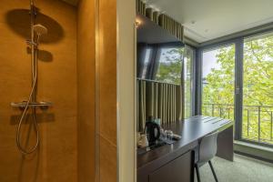 a bathroom with a shower and a counter with a sink at Green Hotel in Genk