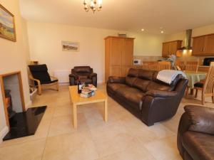 a living room with a couch and a coffee table at Foyle Cottage in Strabane