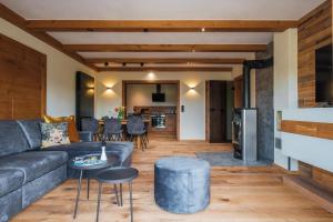 a living room with a couch and a table at Hotel MY Kramerwirt in Geiersthal