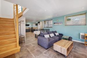 a living room with a couch and a table at Gite Dune 3km plage in Telgruc-sur-Mer