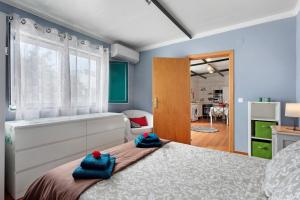 a bedroom with a bed with blue towels on it at Casinha do coração do Oeste in Cadaval +25 photos