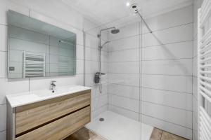 a bathroom with a shower and a sink and a mirror at Gite Dune 3km plage in Telgruc-sur-Mer +16 photos