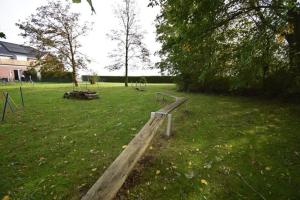 a park with a wooden bench in the grass at Ferienappartment Lhasa Apso in Dornum