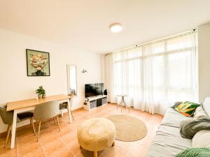 a living room with a couch and a table at Apartamento MN Estorde by ALÔGA in Vilar