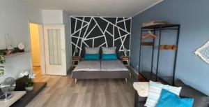 a bedroom with a bed with blue pillows on it at Gemütliche Ferienwohnung im Lotsenviertel in Cuxhaven