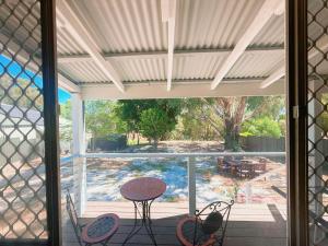 a screened in porch with a table and chairs at Perth property - Heritage Charm Meets Modern Ease close to all amenities including Midland Hospital in Midland Junction