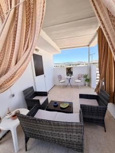 a living room with chairs and a table at Cleopatra's House Apartments in Archangelos