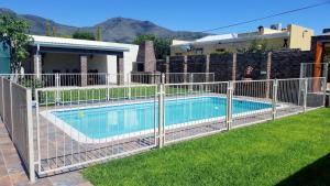 a fence around a swimming pool in a yard at Protea House in Graaff-Reinet