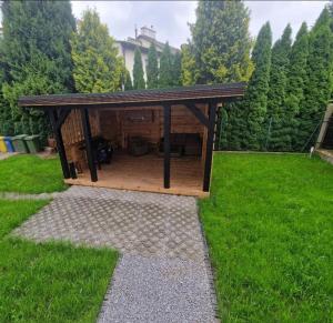 a wooden gazebo in a grassy yard at Zacisze 4 in Przemyśl
