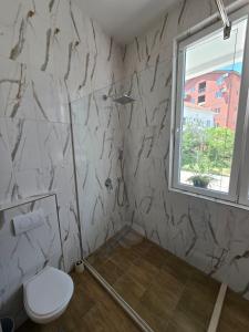a bathroom with a toilet and a window at Villa Iper Krystallos in Budva