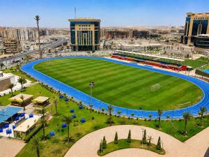 an empty soccer field in the middle of a city at Jewel Plaza and Aqua Park in Cairo