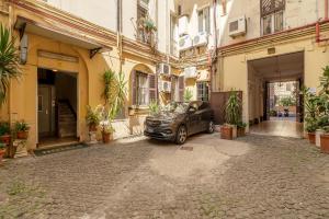 a car parked in an alley between two buildings at Hotel Beauty Palace - Vertex Group in Rome +16 photos