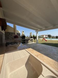 a concrete patio with a fireplace in a house at LA PERLA MARE- Wi-fi and free parking in Capo Vaticano